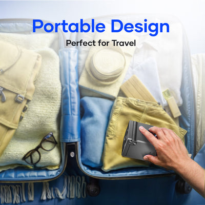 Hand packing compact portable charger into suitcase, ideal for travel accessories