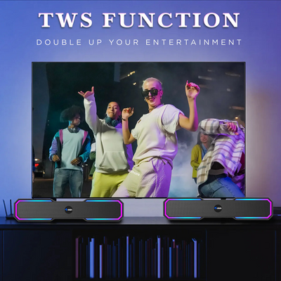 Dual wireless speakers with TWS function on TV stand showing people dancing on screen